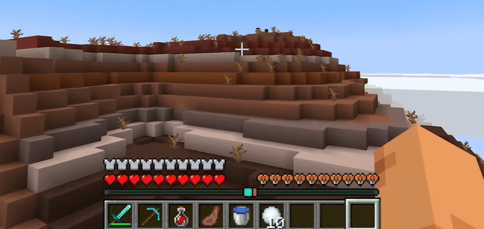 The new Locator Bar UI showing a teal indicator above the hotbar in a badlands biome